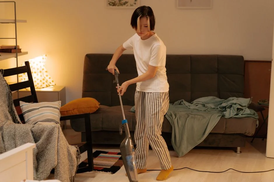 Housekeeper organizing towels in a hotel room, showcasing the art of cleanliness and service.